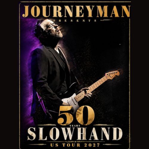 A bearded man in a black suit plays an electric guitar against a dark background with purple lighting. Text reads: Journeyman Presents 50 Years Slowhand US Tour 2027.