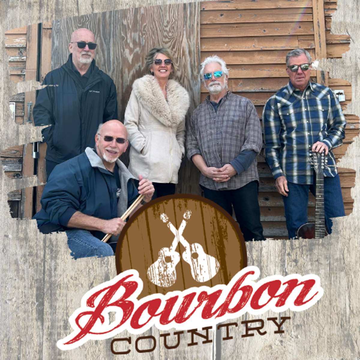 A band of five musicians poses in front of a rustic wooden wall, with the text Bourbon Country and a graphic of two crossed acoustic guitars overlaid at the bottom.